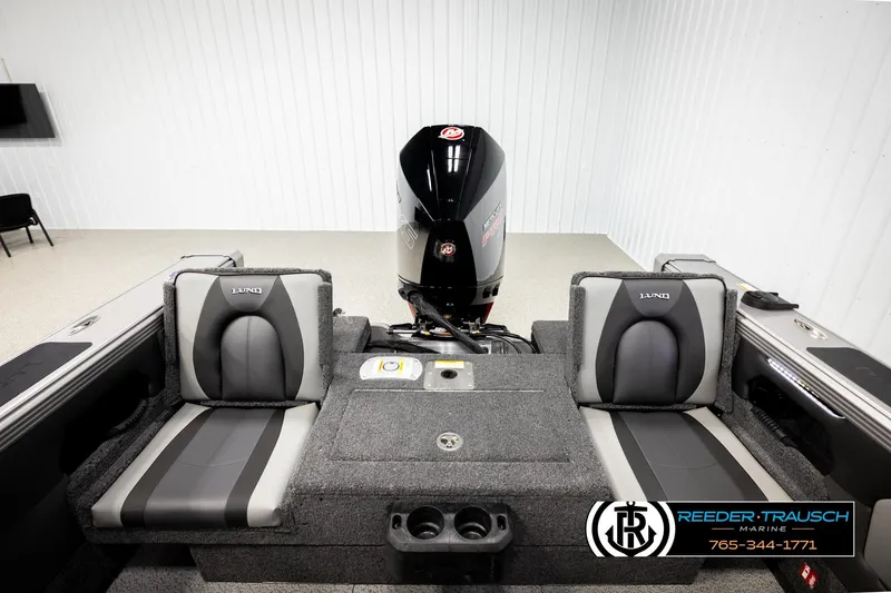 Slide: The Image of 2026 Lund 1975 Tyee boat interior with seating and motor, displayed at Reeder-Trausch Marine. - 18