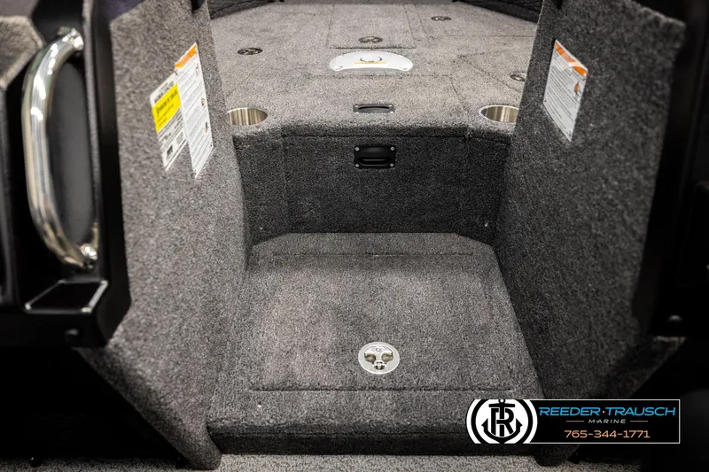 Slide: The Image of Interior of 2026 Lund 1975 Tyee boat with carpeted flooring and storage compartments. - 23