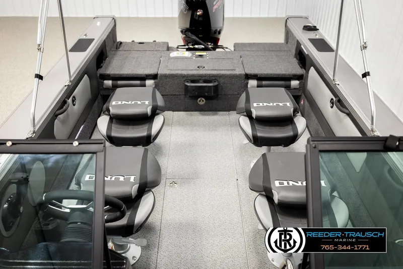 Slide: The Image of 2026 Lund 1975 Tyee boat interior with seating and steering wheel, Reeder-Trausch Marine branding. - 26