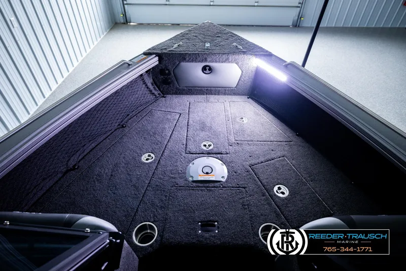 Slide: The Image of Interior view of 2026 Lund 1975 Tyee boat with carpeted deck and storage compartments. - 28