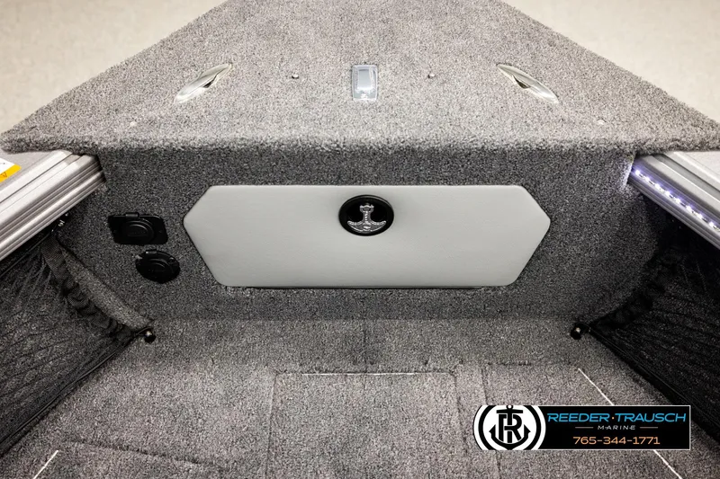 Slide: The Image of Interior of 2026 Lund 1975 Tyee boat with carpeted storage and Reeder-Trausch Marine logo. - 29