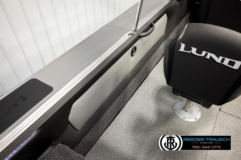 Slide: The Image of Interior of 2026 Lund 1975 Tyee boat with branded seating and carpeted flooring. - 33
