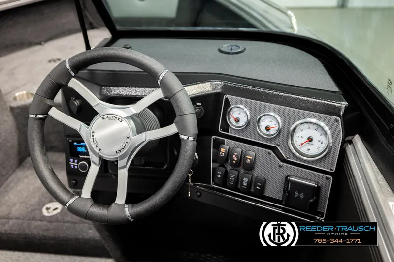 Slide: The Image of Steering wheel and dashboard of 2026 Lund 1975 Tyee boat with gauges and controls. - 35