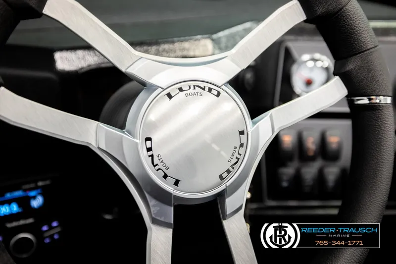 Slide: The Image of Steering wheel of 2026 Lund 1975 Tyee boat with Reeder-Trausch Marine logo. - 37