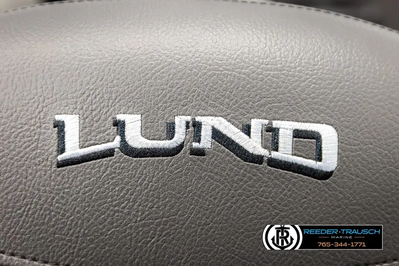 Slide: The Image of Lund 1975 Tyee 2026 logo on gray leather surface, Reeder-Trausch Marine branding. - 43