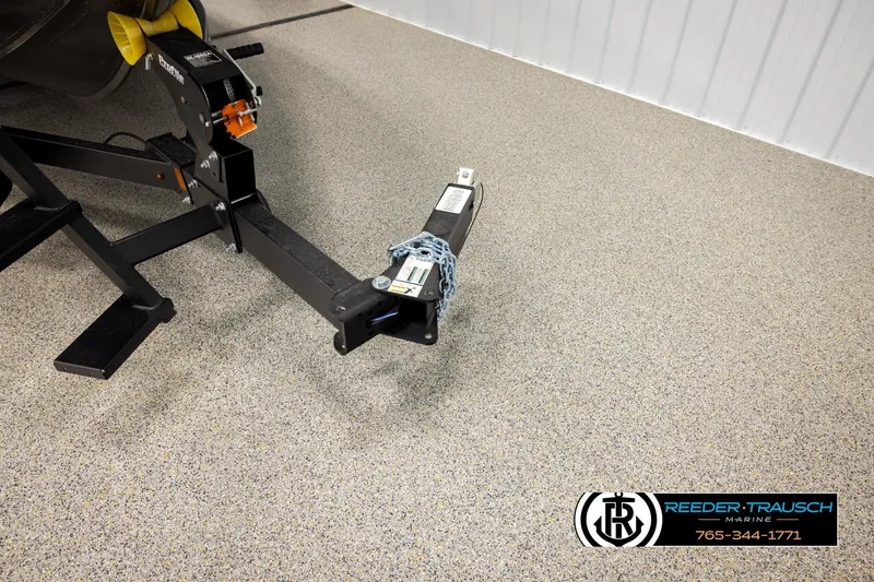 Slide: The Image of Trailer hitch of 2026 Lund 1975 Tyee boat in showroom with Reeder-Trausch Marine logo. - 49