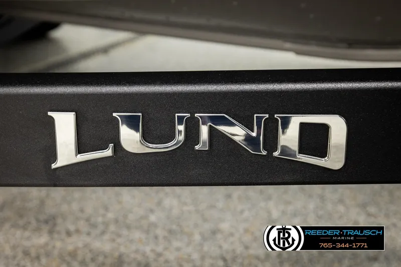 Slide: The Image of Lund 1975 Tyee 2026 model logo on a boat, Reeder-Trausch Marine branding. - 56