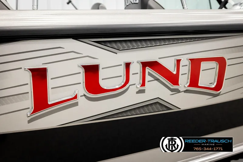 Slide: The Image of 2026 Lund 1975 Tyee boat with bold red logo and sleek design. - 57