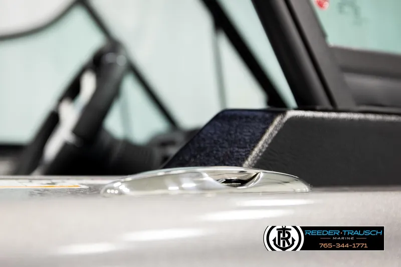 Slide: The Image of Close-up of 2026 Lund 1975 Tyee boat interior with steering wheel and logo. - 59