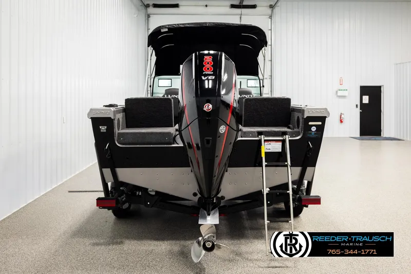 Slide: The Image of 2026 Lund 1975 Tyee boat with powerful V8 engine in showroom. - 6