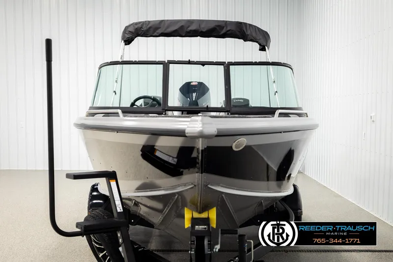 Slide: The Image of 2026 Lund 1975 Tyee boat in showroom, front view with trailer. - 7