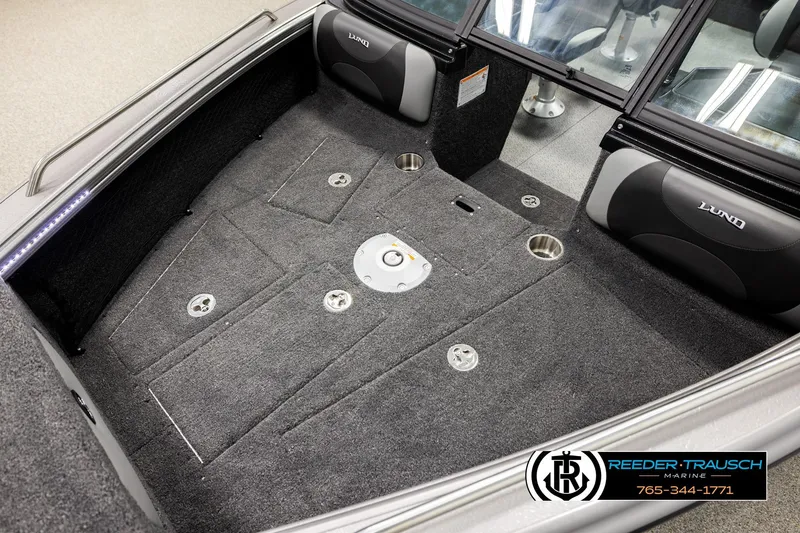 Slide: The Image of Interior of 2026 Lund 1975 Tyee boat with carpeted flooring and storage compartments. - 9