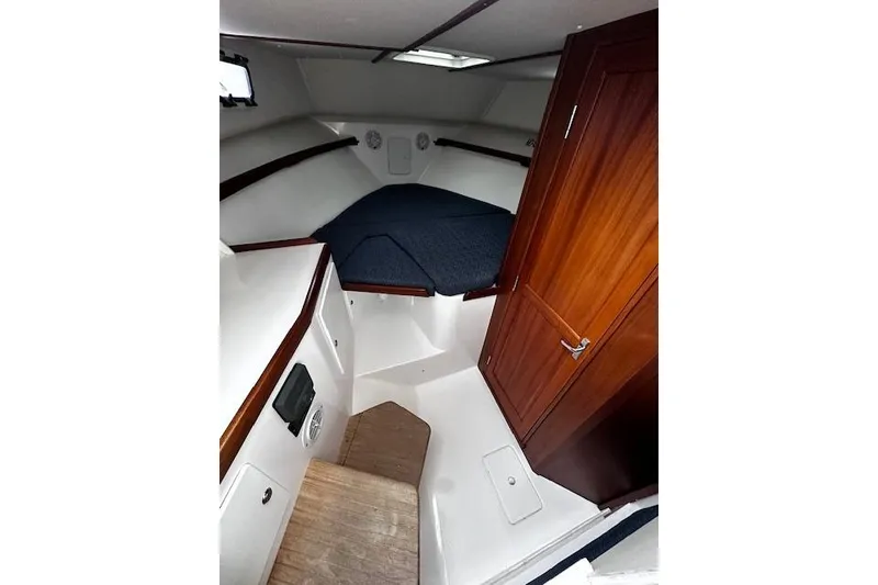 Slide: The Image of 2021 NorthCoast 315 Cabin interior with wood accents and cozy sleeping area. - 12