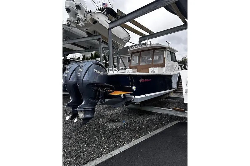 Slide: The Image of 2021 NorthCoast 315 Cabin boat with dual Yamaha 300 engines on a trailer. - 3