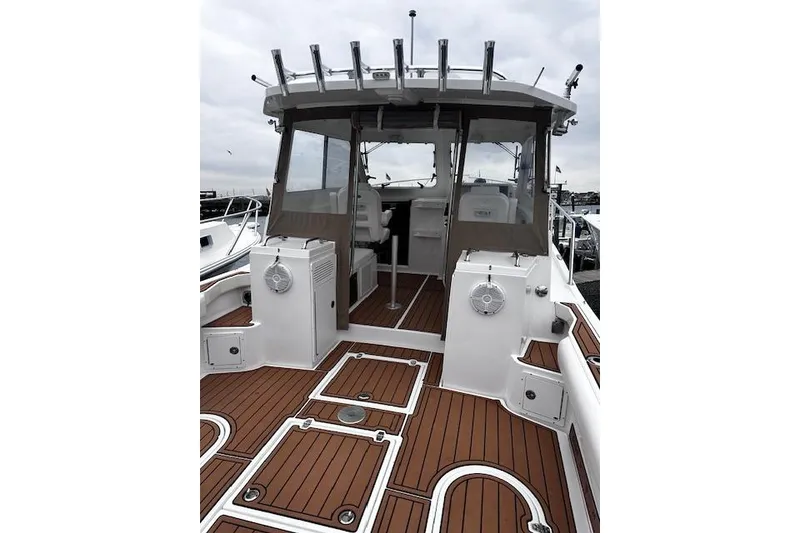 Slide: The Image of 2021 NorthCoast 315 Cabin boat with teak deck and enclosed cockpit. - 6