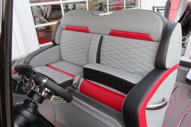 Slide: The Image of 2025 Sunsation 32 CCX boat interior with stylish gray and red seating and steering wheel. - 13