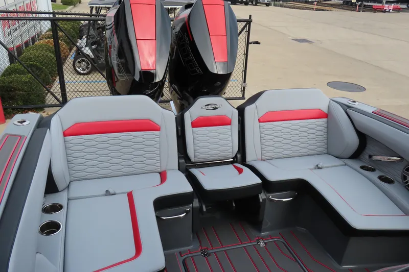 Slide: The Image of 2025 Sunsation 32 CCX boat interior with gray and red seating, dual engines visible. - 18