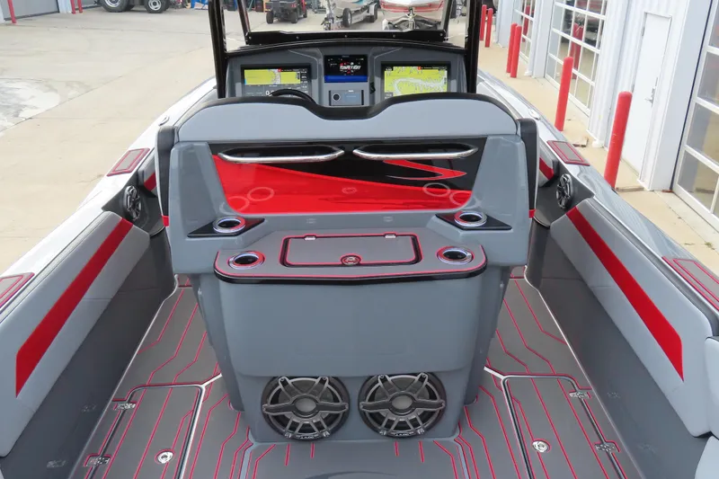 Slide: The Image of 2025 Sunsation 32 CCX boat interior with modern dashboard and red accents. - 19