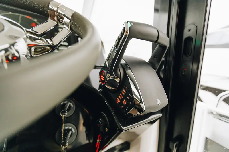 Slide: The Image of Close-up of 2026 Beneteau Antares 11 Fly steering wheel and throttle controls. - 10