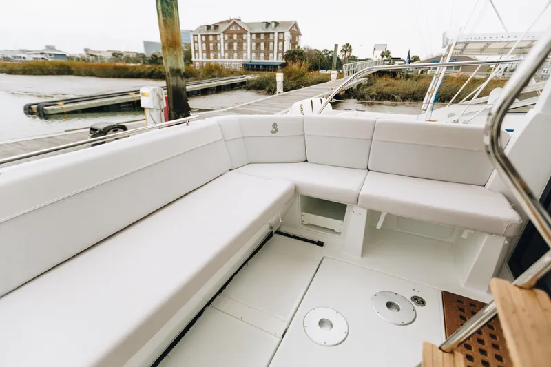 Slide: The Image of 2026 Beneteau Antares 11 Fly yacht with spacious white seating area at dock. - 17
