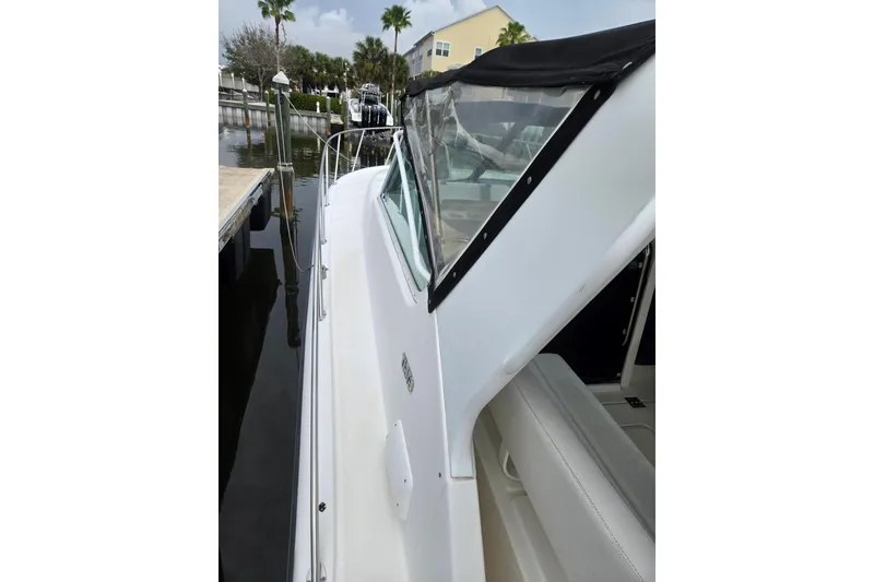 Slide: The Image of 2002 Tiara Yachts 3500 Open docked, showcasing sleek white exterior and canopy. - 16