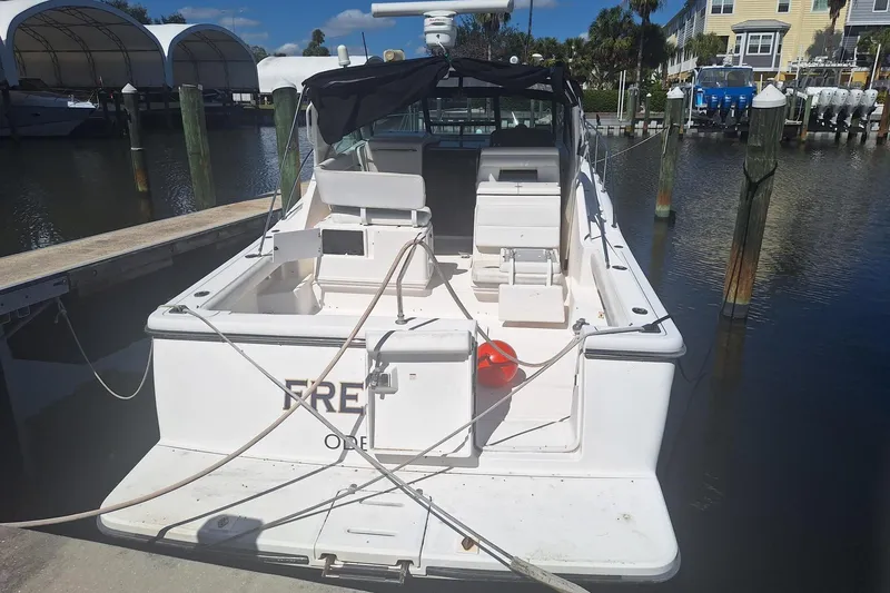 Slide: The Image of 2002 Tiara Yachts 3500 Open docked at marina, rear view. - 21
