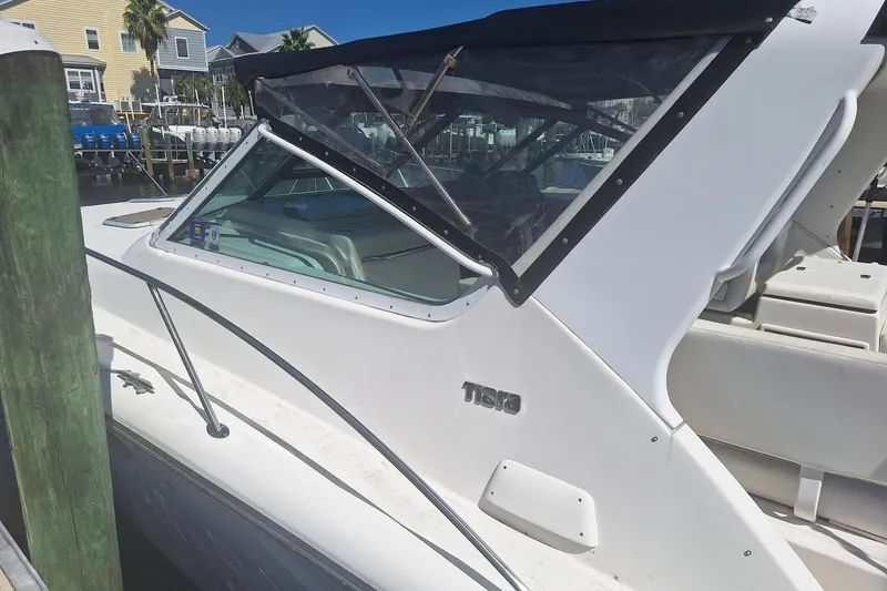 Slide: The Image of 2002 Tiara Yachts 3500 Open docked, featuring sleek white design and covered cockpit. - 24