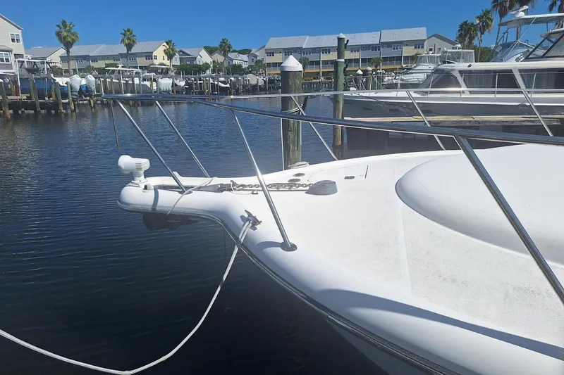 Slide: The Image of 2002 Tiara Yachts 3500 Open docked in a marina with waterfront homes. - 25