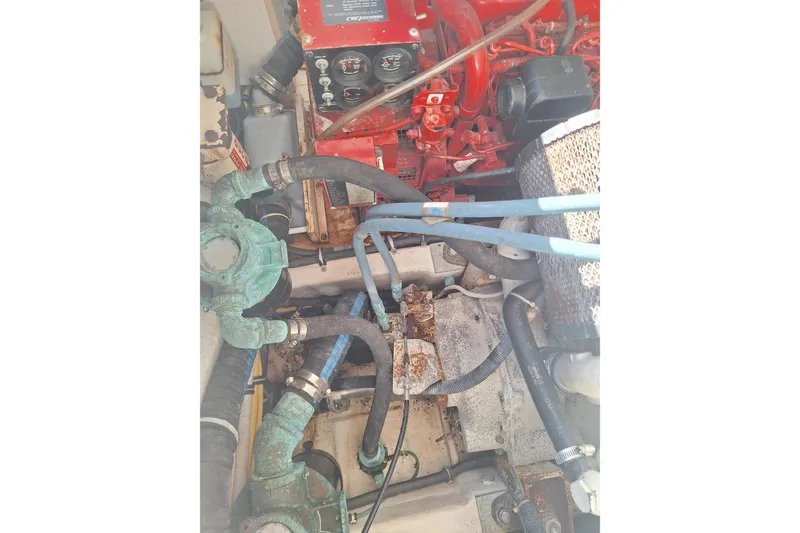 Slide: The Image of Engine compartment of a 2002 Tiara Yachts 3500 Open, showcasing hoses and mechanical components. - 29