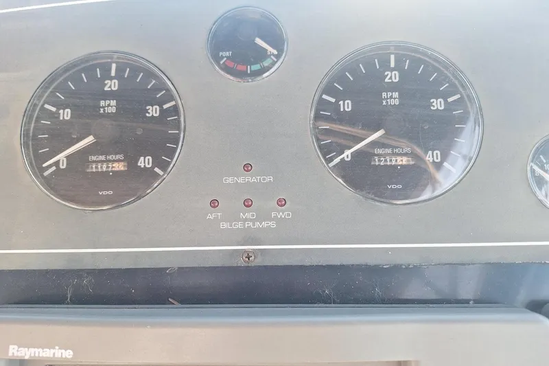 Slide: The Image of Dashboard of 2002 Tiara 3500 Open boat with RPM gauges and bilge pump indicators. - 9