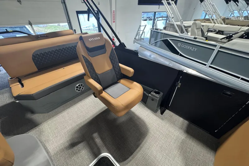 Slide: The Image of 2026 Sylvan L3 DLZ boat interior with tan seating and modern design. - 14