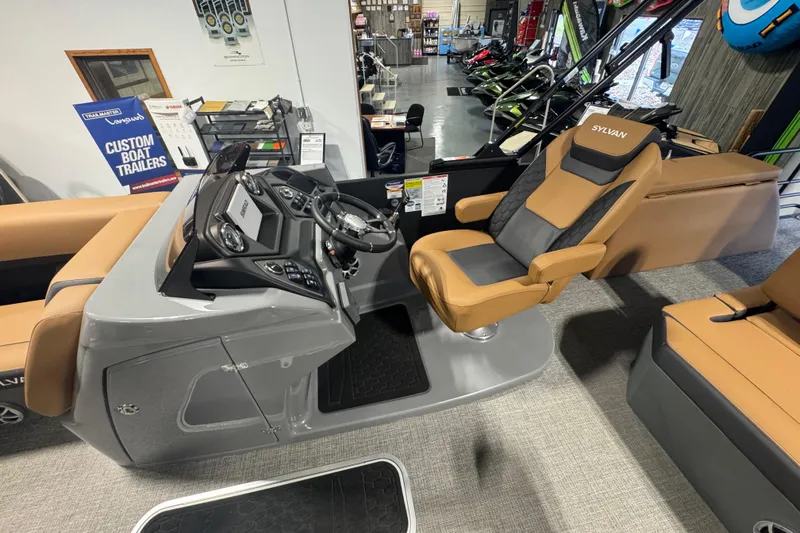 Slide: The Image of 2026 Sylvan L3 DLZ boat interior with captain's chair and control panel in showroom. - 15