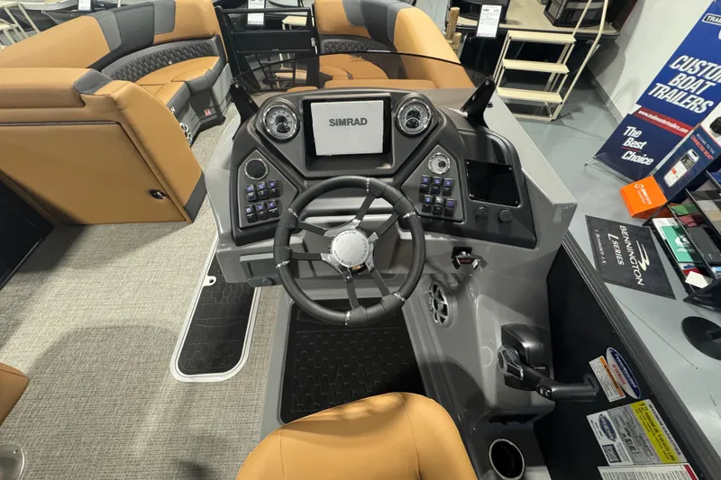 Slide: The Image of 2026 Sylvan L3 DLZ boat dashboard with steering wheel and Simrad display. - 17
