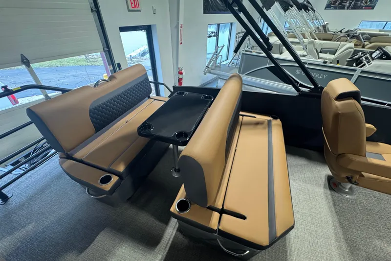 Slide: The Image of 2026 Sylvan L3 DLZ boat interior with tan seating and black table. - 19