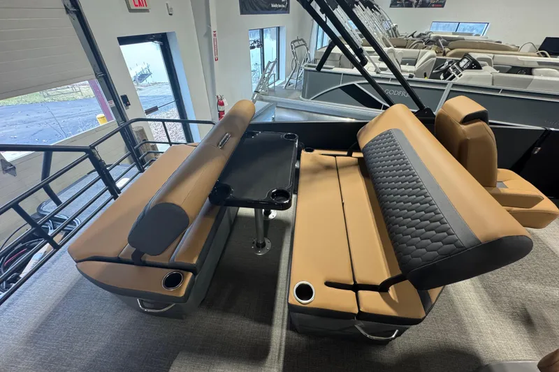 Slide: The Image of Luxurious seating area on 2026 Sylvan L3 DLZ pontoon boat with tan and black upholstery. - 20