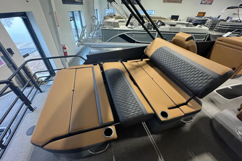 Slide: The Image of Luxurious seating on 2026 Sylvan L3 DLZ pontoon boat, featuring tan and black upholstery. - 21