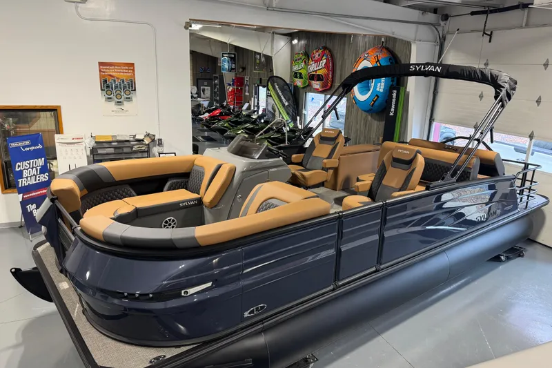 Slide: The Image of 2026 Sylvan L3 DLZ pontoon boat with luxurious seating in showroom. - 4