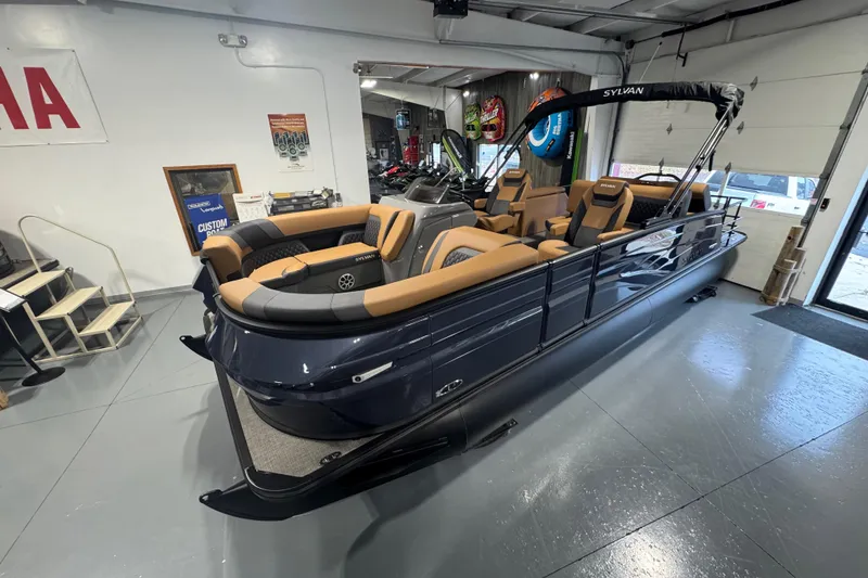 Slide: The Image of 2026 Sylvan L3 DLZ pontoon boat with luxurious seating in a showroom. - 5