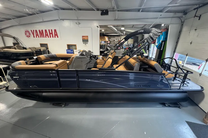 Slide: The Image of 2026 Sylvan L3 DLZ pontoon boat displayed in showroom with Yamaha signage. - 6