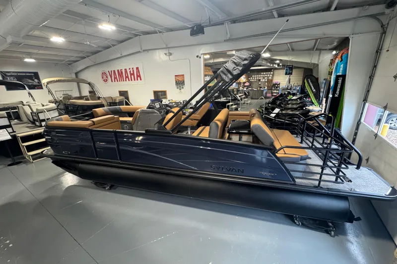 Slide: The Image of 2026 Sylvan L3 DLZ pontoon boat displayed in a showroom with Yamaha signage. - 7