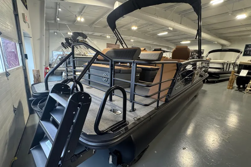 Slide: The Image of 2026 Sylvan L3 DLZ pontoon boat displayed in a showroom with sleek design. - 9