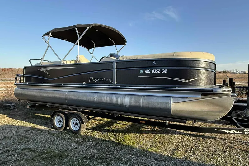 Slide: The Image of 2021 Premier 250 RE Sunsation LTD pontoon boat on trailer, outdoor setting. - 12