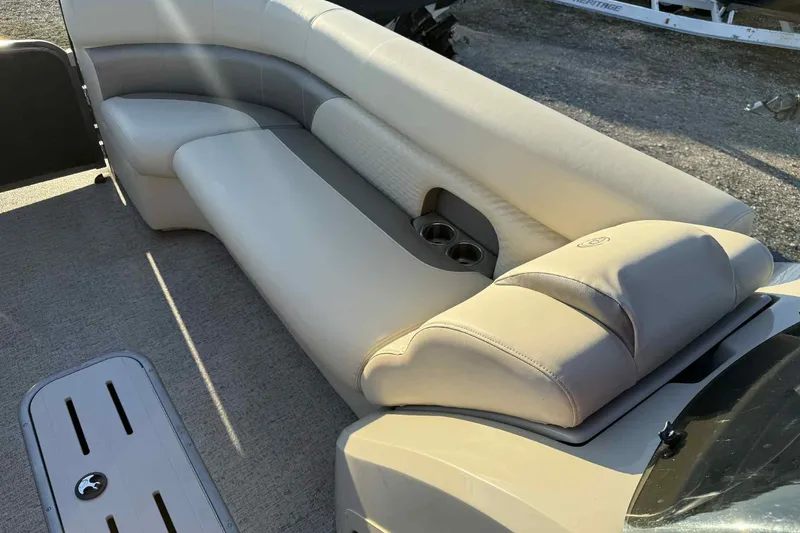Slide: The Image of Luxurious seating on 2021 Premier 250 RE Sunsation LTD pontoon boat, featuring cup holders. - 16