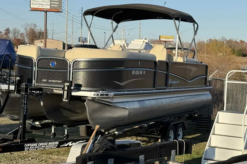 Slide: The Image of 2021 Premier 250 RE Sunsation LTD pontoon boat on trailer, outdoor setting. - 5