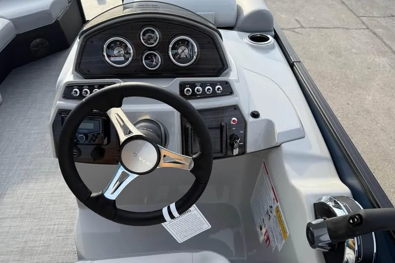 Slide: The Image of Steering console of 2026 Lowe SS 230 DV boat with modern controls and gauges. - 11