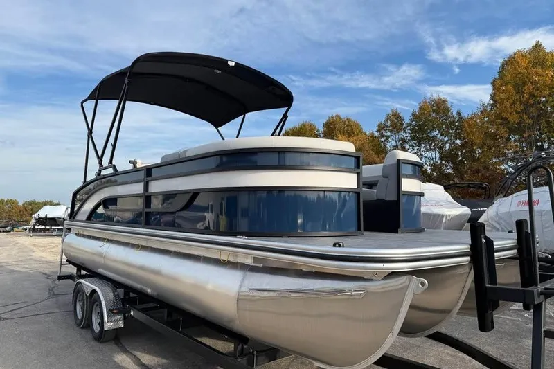 Slide: The Image of 2026 Lowe SS 230 DV pontoon boat on trailer under blue sky. - 3