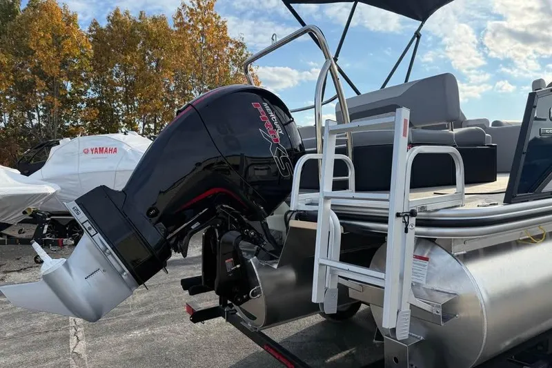 Slide: The Image of 2026 Lowe SS 230 DV pontoon boat with Mercury outboard motor, docked outdoors. - 5