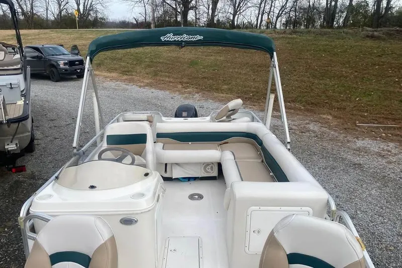 Slide: The Image of 2005 Hurricane FunDeck 196 FF boat with seating, parked on gravel near trees. - 8