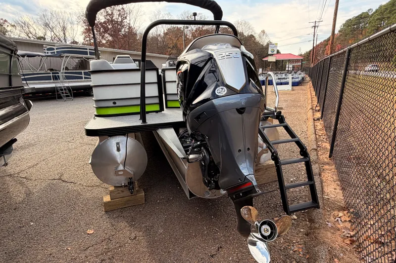 Slide: The Image of 2026 Veranda Vista Sport VS25RC pontoon boat with powerful outboard motor, parked outdoors. - 4
