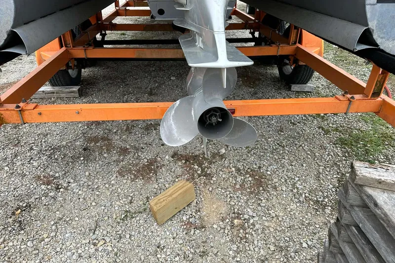 Slide: The Image of 2004 PlayCraft Powertoon 26 propeller on orange trailer, gravel ground. - 10